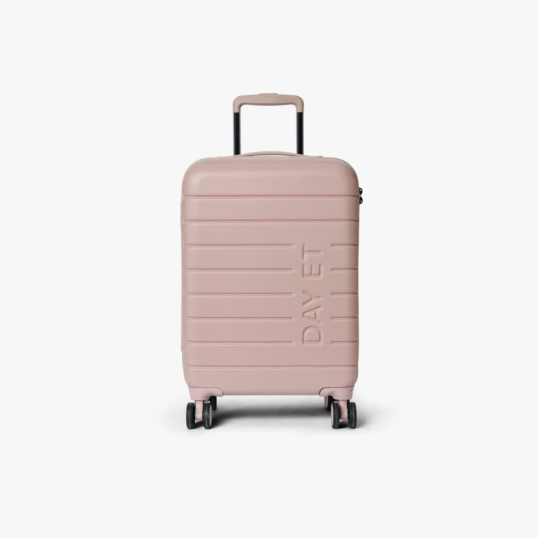 Pink suitcase with 'DAY ET' branding on a white background